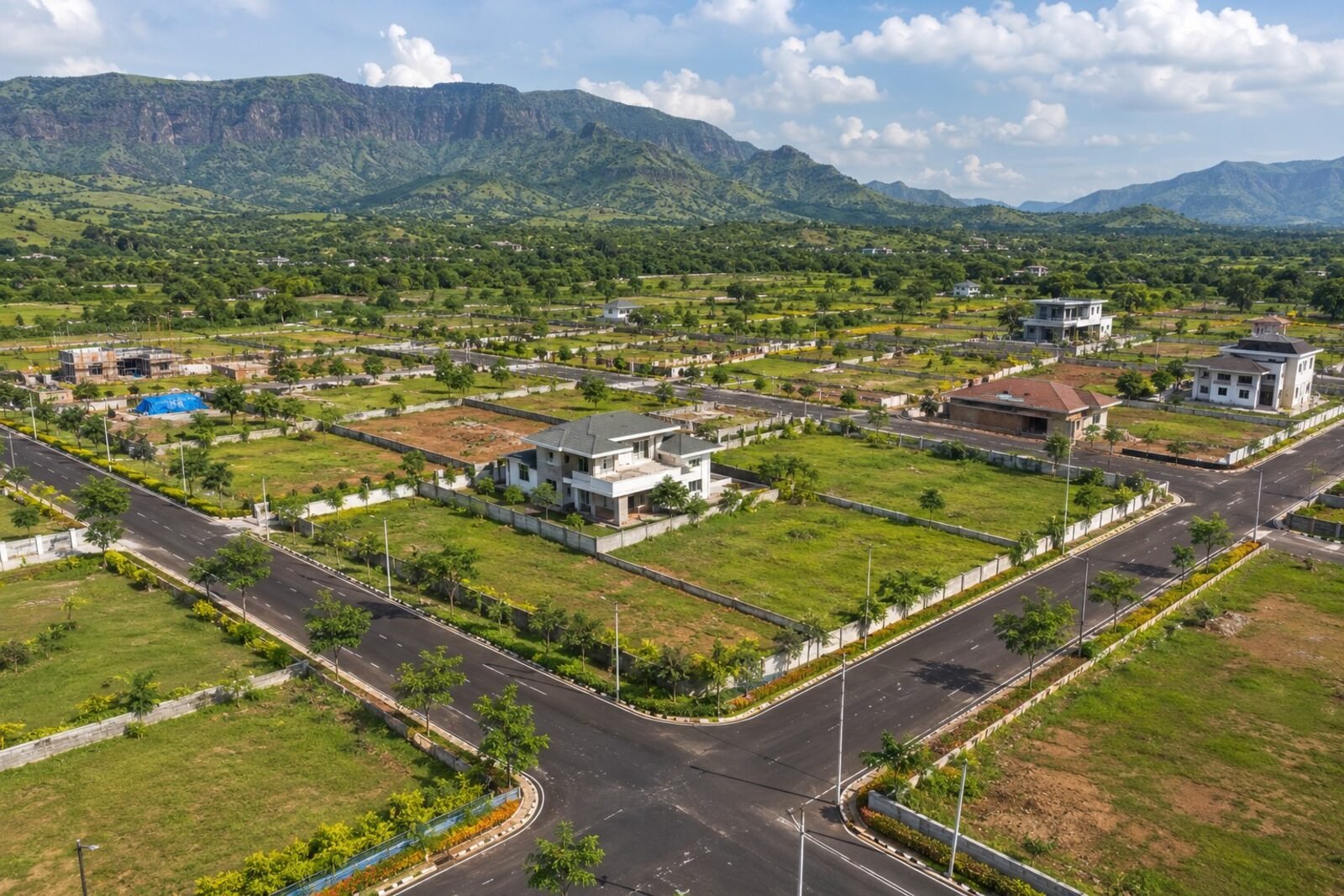 Planned NA plot and villa layouts with landscaped roads against the Sahyadri foothills in Karjat